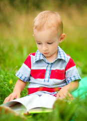 Little boy is reading book