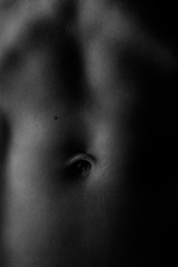 Closeup of fit lady's belly, monochrome