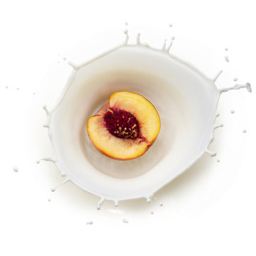 Peach in milk splash on white