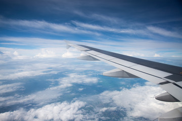 Fototapeta na wymiar Wing of an airplane flying in the sky so beautiful.