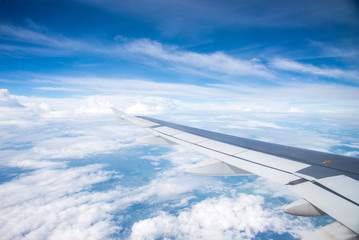 Fototapeta na wymiar Wing of an airplane flying in the sky so beautiful.