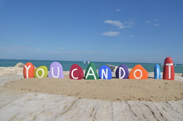 You can do it, colored stones composition on the sand