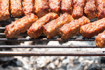 minced meat rolls on grill (traditional Romanian food) mici