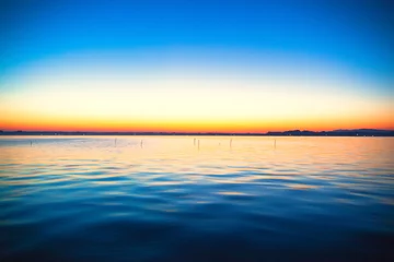 Foto op Canvas Blue and orange gradation of sunset on the lake Kasumigaura © shihina