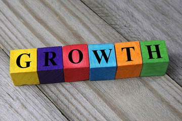 word growth on wooden colorful cubes