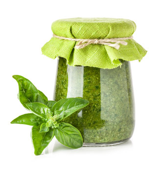 Glass Jar Of Pesto Sauce Isolated On White