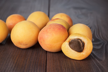 Naklejka na ściany i meble some fresh apricots on brown table