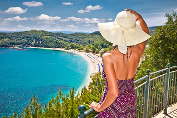 Beautiful woman looking on Valtos beach near Parga, Greece.