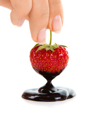 Woman hand holding chocolate-dipped strawberry