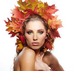 Autumn woman dressed in red leaves