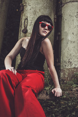 stylish girl in red pants and glasses