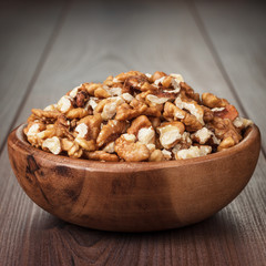 walnuts in the brown wooden bowl