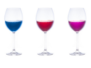 Three glasses with colorful liquids inside