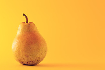Beautiful ripe yellow pear on yellow background
