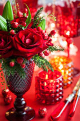 Christmas table decoration with flowers and candles