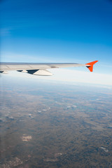 Fototapeta na wymiar Airplane wing out of window