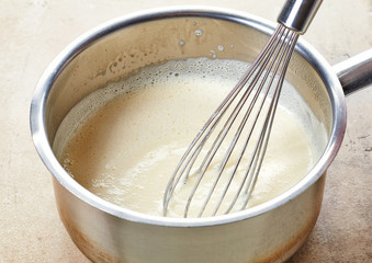 Fototapeta na wymiar making vanilla sauce in a pot