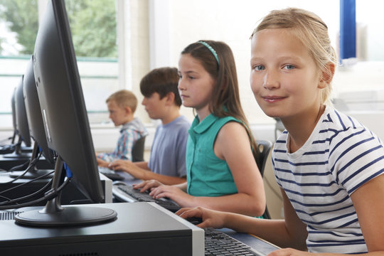 Group Of Elementary School Children In Computer Class