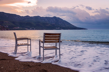 Fototapeta na wymiar two chairs on the beach