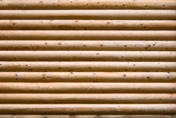 Fototapeta premium Wall of planed wooden logs.