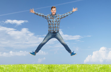 smiling young man jumping in air