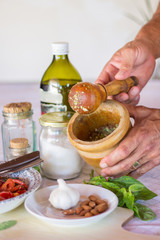 Man preparing ingredients for cooking using mortar and pestle