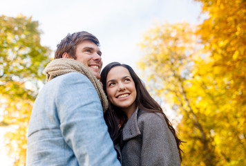 Fototapeta premium smiling couple hugging in autumn park