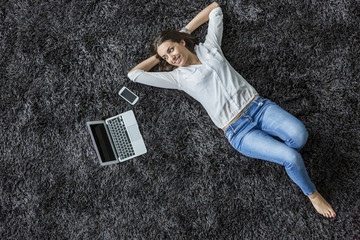 Young woman laying on the carpet