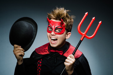 Funny devil against dark background