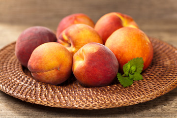 Fresh peaches on wood background. Selective focus.