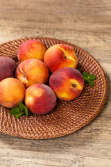 Fresh peaches on wood background. Selective focus.