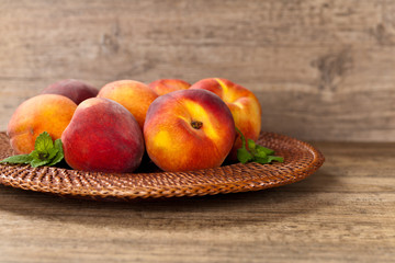Fresh peaches on wood background. Selective focus.