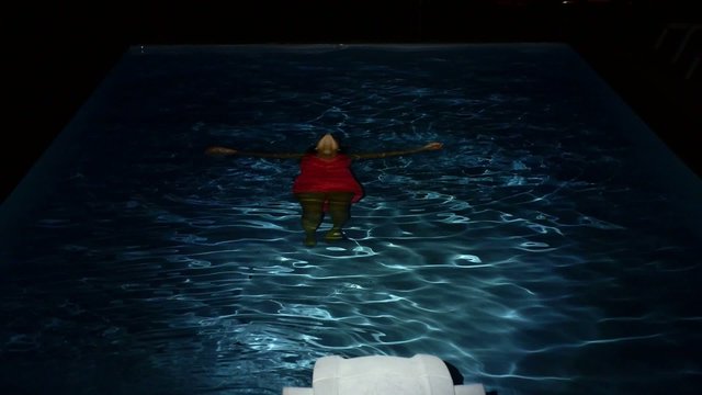 Young Drowned Woman Lying in Pool Water at Night. Slow Motion.