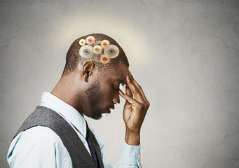 Man thinking hard, gear mechanisms over head, brain power