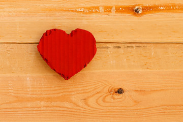 Love Valentines red cardboard heart on rough pine background
