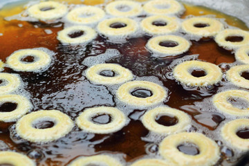 making donuts fried in a pan