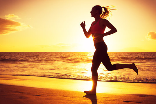 Woman running at sunset