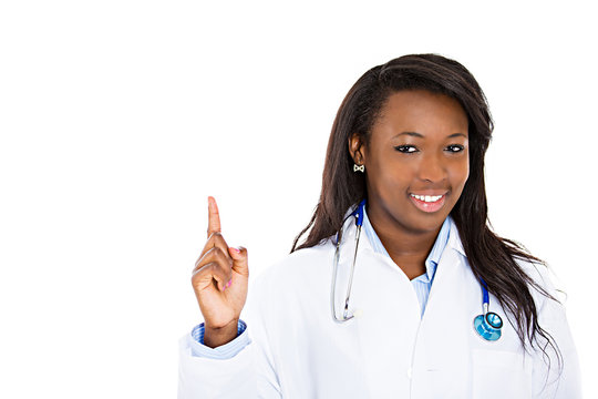 Female doctor nurse pointing up with finger at copy space