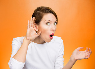 Nosy surprised woman hand to ear gesture, carefully listens