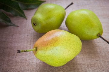 Fresh pears on wooden background