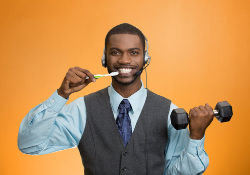 Multitasking businessman on orange background