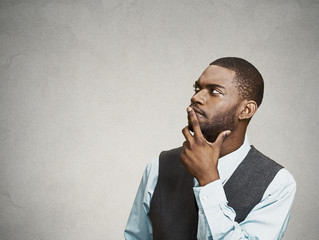 Man thinking, deciding on his future planning, looking up