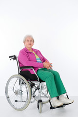 female senior in wheelchair in front of white background