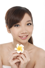 beautiful young woman with frangipani on hands