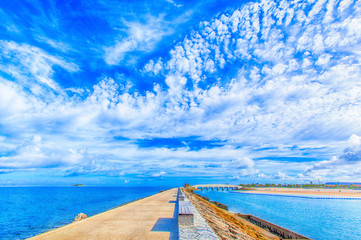 Breakwater with benches and blue sky