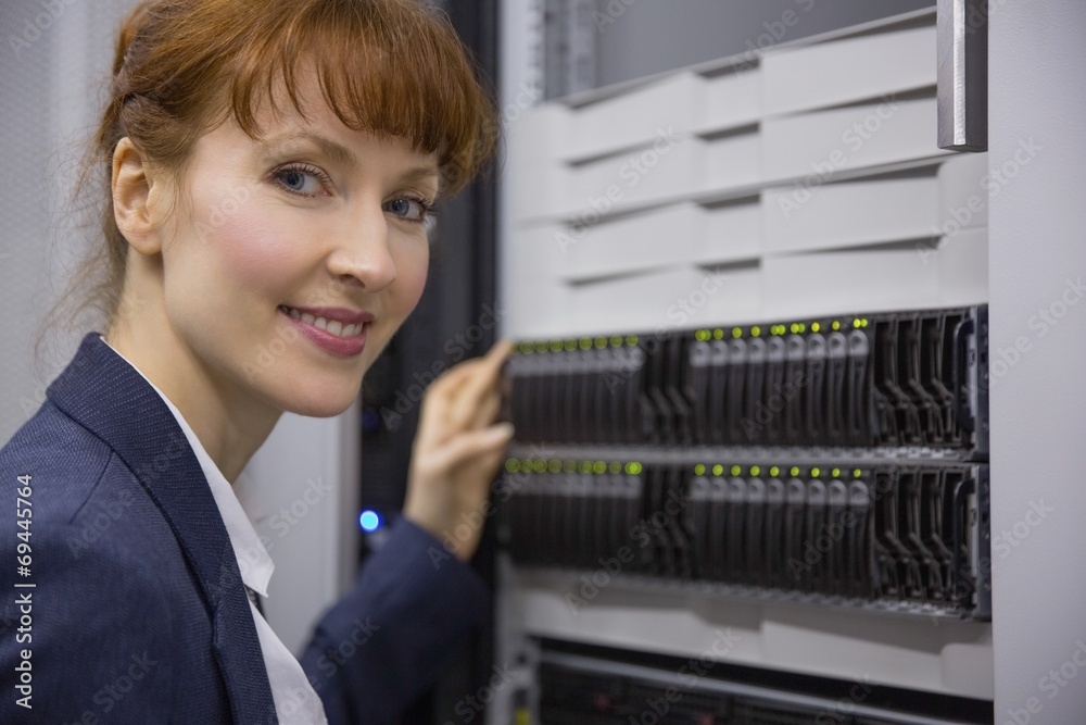 Aufkleber pretty technician smiling at camera beside server tower