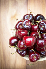 Fresh cherries in bowl on table