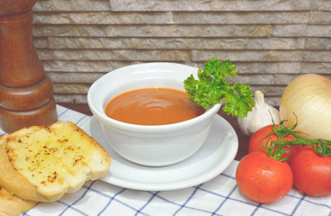 Tomato soup with ingredients Garlic Bread