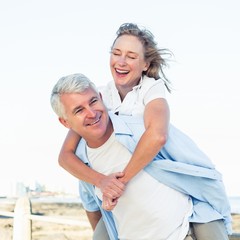 Casual couple having fun by the sea