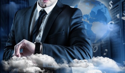 Composite image of businessman checking the time on watch